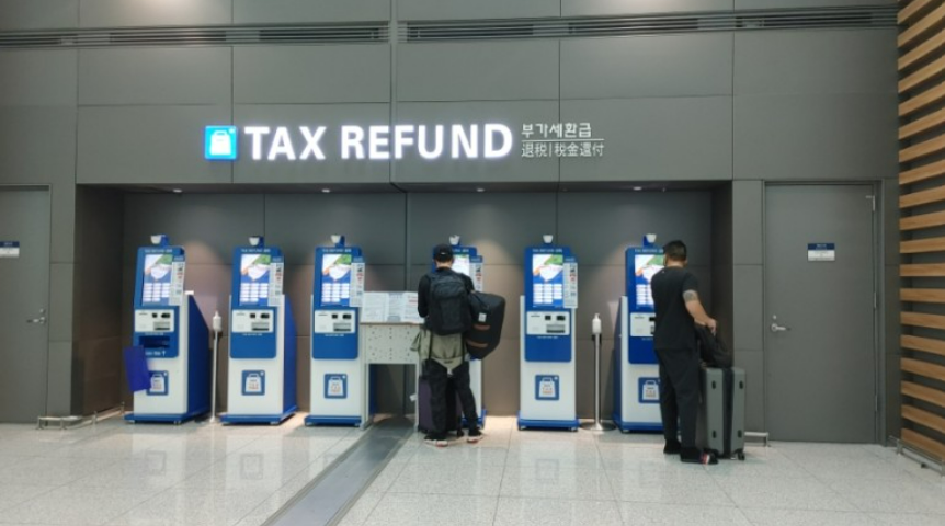 People standing in front of a tax refund machine

Description automatically generated